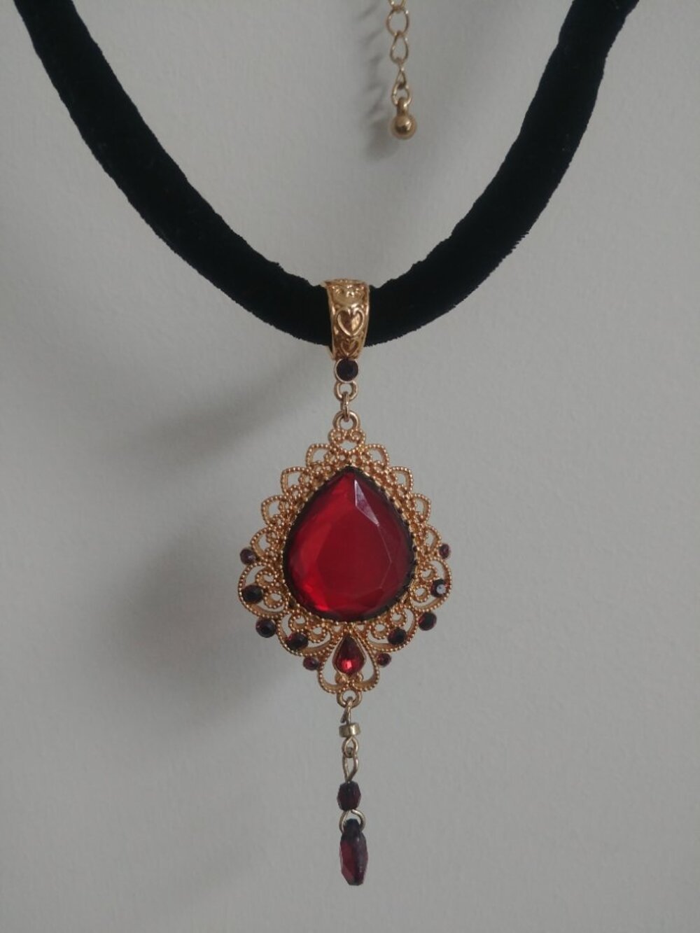 Intricate gold tone pendant with large stone on short velvet necklace gothic